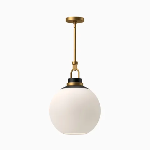 Aged gold pendant light with matte opal glass globe shade and contrasting black accents, suspended from a matching aged gold canopy.