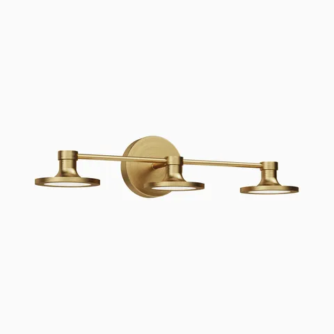 Brushed gold three-light wall sconce with a horizontal bar and three flat circular shades on a round backplate.
