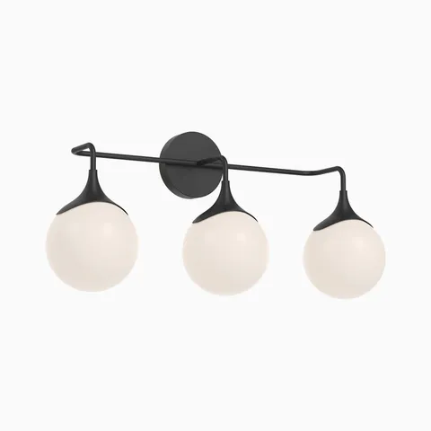 Modern matte black vanity light with three frosted glass globe shades arranged along a slim horizontal arm, creating soft even illumination above mirrors.
