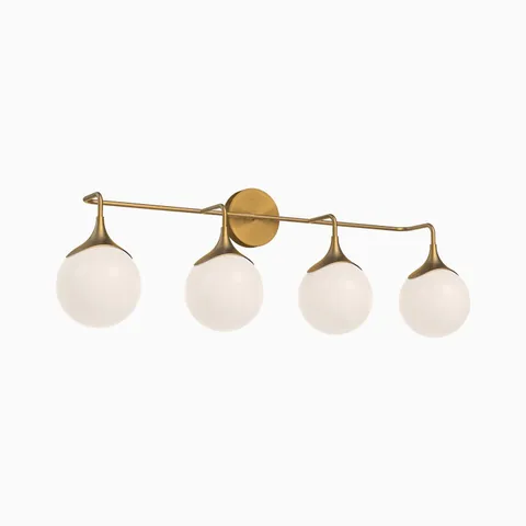 Modern brushed gold vanity light with four frosted glass globe shades arranged along a slim horizontal arm, creating soft even illumination above mirrors.