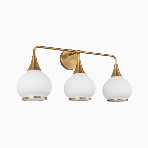 Aged gold three-light wall sconce with matte opal glass globe shades.