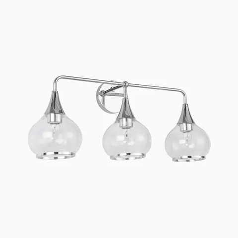 Chrome three-light wall sconce with clear glass globe shades.