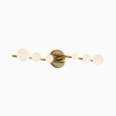 Modern LED vanity light in brushed gold with a linear bar and six frosted glass globe bulbs, creating warm even illumination suited for contemporary bathroom spaces.