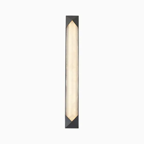 Vertical LED wall sconce with warm alabaster-style diffuser and dark metal frame with geometric brass accents.