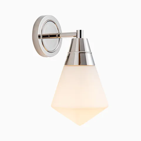 Polished chrome wall light with a faceted frosted glass shade and tapered metal socket mounted on a round backplate for a clean modern look.