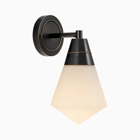 Black wall vanity light with a geometric frosted glass shade and tapered metal detail extending from a circular backplate.