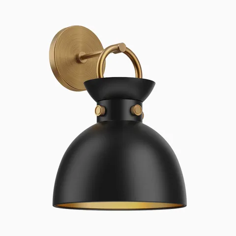 Brushed gold wall vanity light with a matte black dome shade, looped arm detail, and exposed side fasteners mounted on a round backplate.
