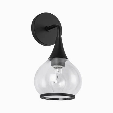 Matte black wall sconce with curved arm and round backplate, featuring a clear glass shade and exposed bulb.