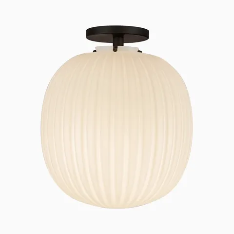 Flush mount ceiling light with a matte black canopy and glossy ribbed opal glass globe shade.