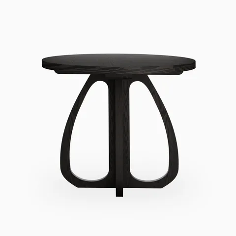 Round black wood dining table with a smooth tabletop and sculptural curved pedestal base, offering a bold, modern statement with organic form.